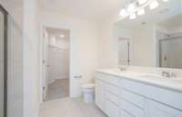 ***Photo from another townhouse recently completed in community with same finishes***  The Owner's Bathroom includes tile flooring and dual sinks with quartz countertops.