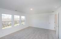 ***Photo from another townhouse recently completed in community with same finishes***  Natural light pours into the Owner's Bedroom from 3 large windows!