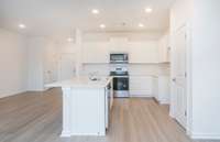 ***Photo from another townhouse recently completed in community with same finishes***  Located right off of the Kitchen is a dining space that will comfortably fit a 6-person table.