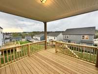 ***Photo taken on 4/10 of actual home for sale***  Covered rear deck with amazing hillside views!