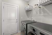 Laundry room leading to 2 car garage