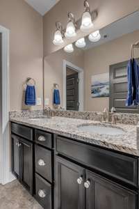 Upstairs full bath features a double bowl vanity and separate wet area.