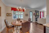 Large Breakfast Room with Pretty Chandelier and a view of the rear treed yard.