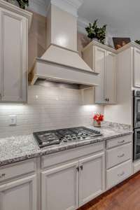 Gas Cooktop features built in Cabinet vent Hood.