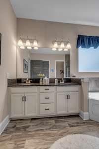 This Owners Bath is very spa like with the Double Bowl Vanity, Corner Tub and Separate  Shower.  The bath also features a linen closet and separate Commode Closet.