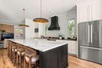 A striking 12-foot island anchors the designer kitchen—perfect for gathering, cooking, and everyday living.