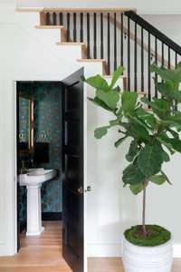 Surprise! A boldly designed half bath is tucked under the stairs.