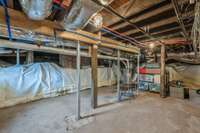 Access to additional basement storage and a secure storm shelter is discreetly tucked beneath the laundry room floor.