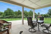 The covered patio offers cool shade on sunny days and a serene spot to relax and enjoy the gentle sound of rain - your private outdoor retreat in any weather.