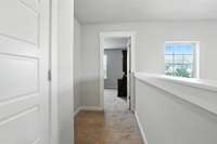 The upstairs hallway leads to the first bedroom (bedroom #2) on the front side of the house