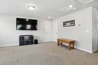 Spacious upstairs family room offering endless flexibility - perfect for movie nights, playtime, or a cozy home office