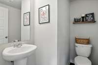 The guest powder room is conveniently located near the entrance.
