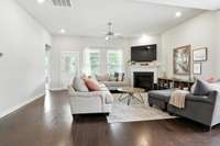 Open-concept living room flows seamlessly into the kitchen, creating an inviting space perfect for gatherings and easily accommodating large crowds.  Exit through the door to the covered patio and backyard.