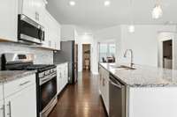 Chef-inspired kitchen with stainless steel appliances and quartz countertops