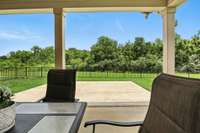 Enjoy added privacy and scenic views with a backyard that opens to lush green space, complete with open grassy areas and a serene wooded backdrop.