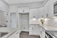 The guest bedroom is conveniently located just off the kitchen.