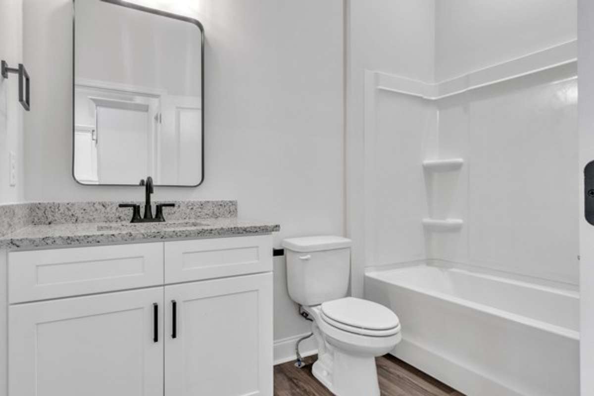 Full bathroom on the 2nd floor with modern decor, fixtures & lighting to serve guest bedroom and living area guests.
