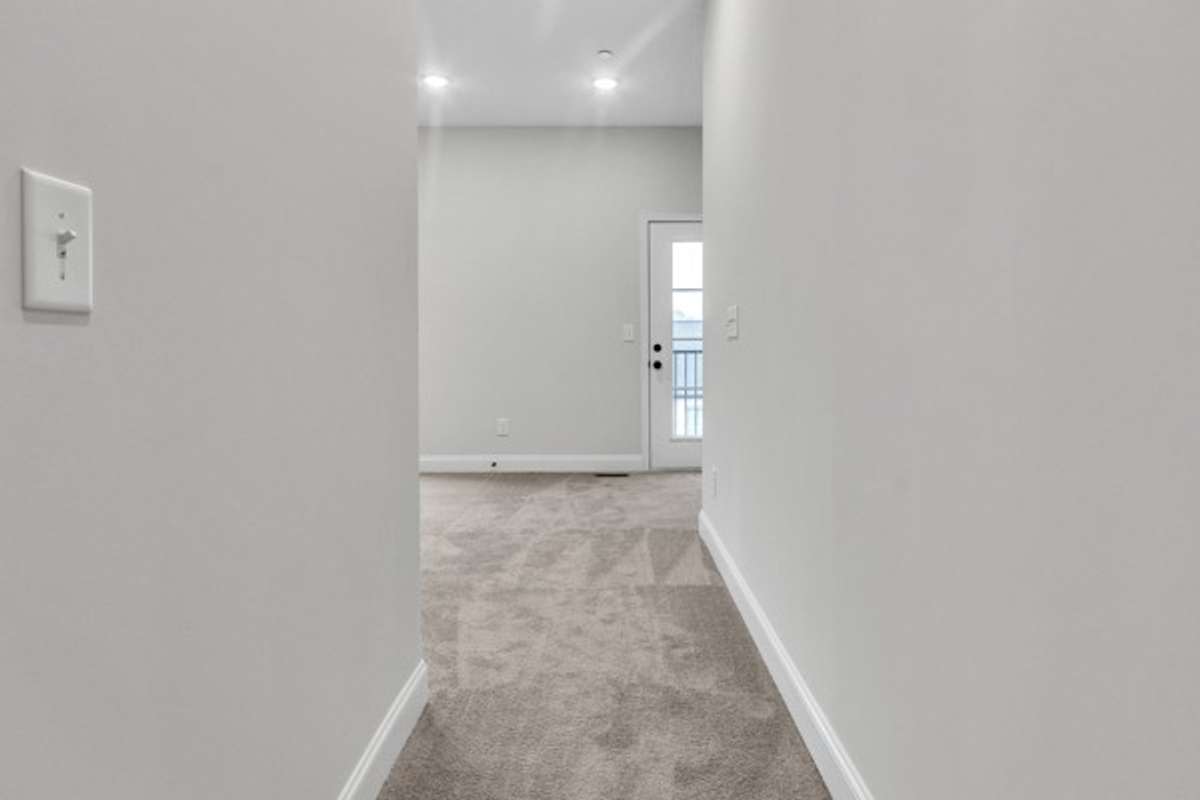 As you enter owner's retreat, you notice the soaring ceilings, multiple windows and lots of light streaming in with the primary bath and owner's walk-in closet to the left.