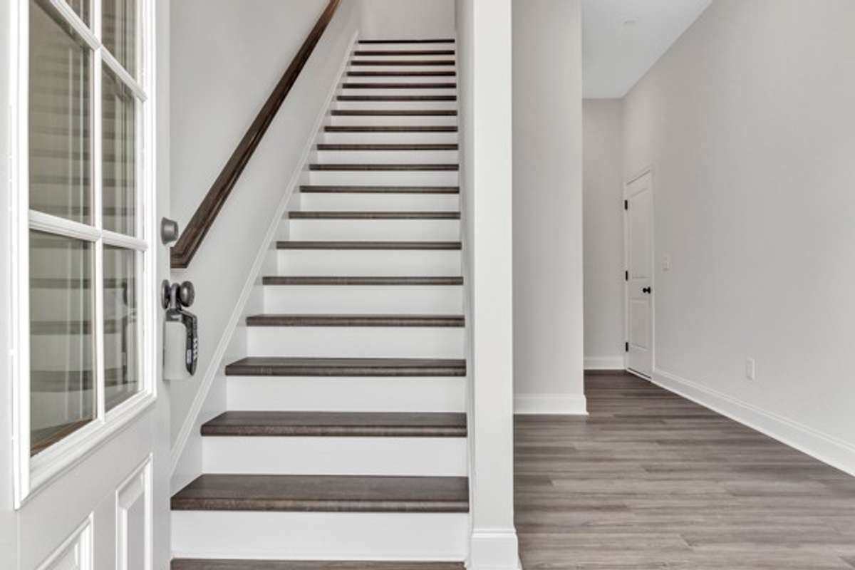 As you enter the 1st floor a private office/flex space is on the right and then a half bath, coat closet and entrance to 2 car garage.