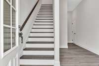 As you enter the 1st floor a private office/flex space is on the right and then a half bath, coat closet and entrance to 2 car garage.