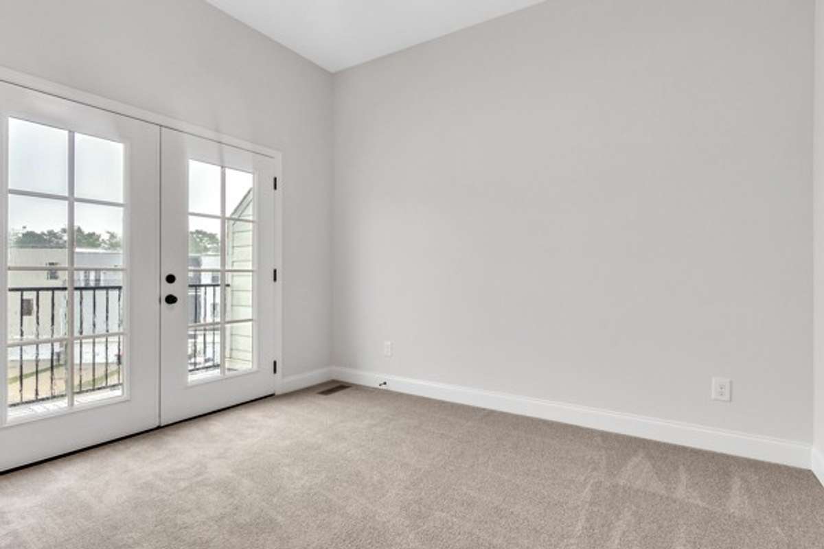 2nd guest bedroom with 10 ft high ceiling, modern ceiling fan & lighting with a private full bath.