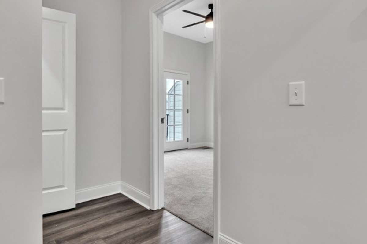 3rd floor landing with laundry room entry to 2nd guest bedroom.