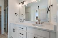 Double vanities, walk-in shower, walk-in closet, and stand alone tub in the primary suite