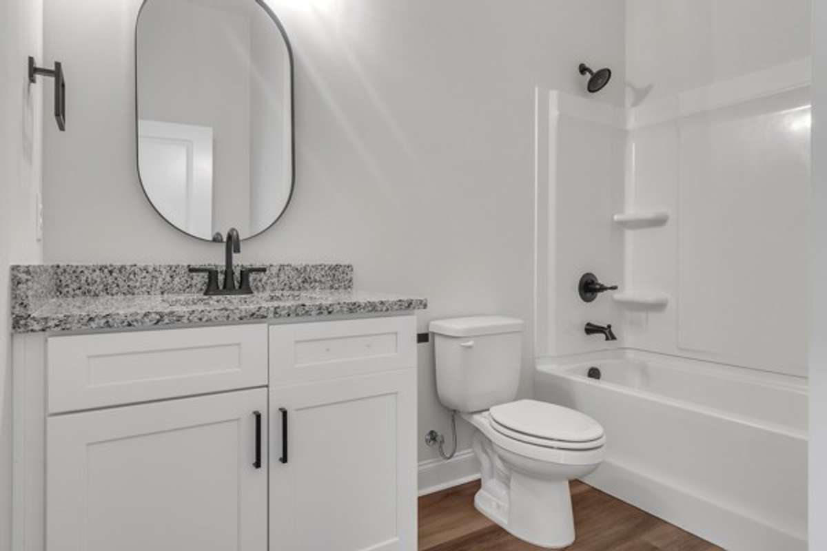 Full bath featuring 10 ft ceilings, granite and modern decor and fixtures.
