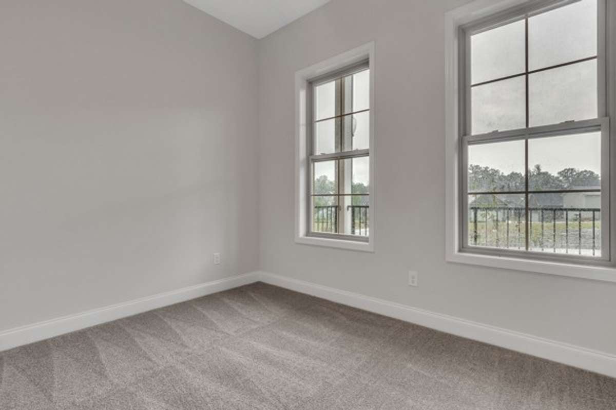 With french doors, large double windows, 10 ft ceilings accompanied with a modern ceiling fan and recessed lighting this guest bedroom will be a favorite.