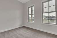 With french doors, large double windows, 10 ft ceilings accompanied with a modern ceiling fan and recessed lighting this guest bedroom will be a favorite.