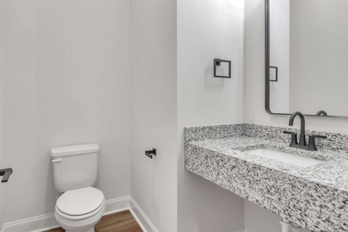 At the landing of 2nd floor is a half bath to serve the kitchen and living spaces.