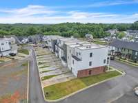 A great shot of the long private driveways & 2 car garages to these 7 unique townhome
