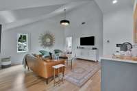 Vaulted ceiling in spacious upstairs den makes this a perfect area for family or guest. Note coffee bar with copper sink and refrigerator.