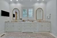 Primary bathroom features double vanities with Quartzite counter tops ( note the veining - was told it is jade)  lots of storage and  marble floor .