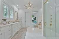View of primary bath, shower and bedroom