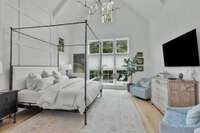 Primary Bedroom features a 20ft. Vaulted ceiling, decorative paneling designer light fixture and wall of windows that overlook the pool.