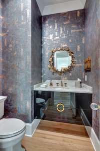 Power room with custom vanity and designer sink.
