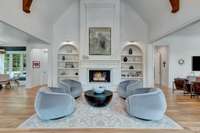 Living room has 20 ft ceiling, gas fireplace , built in bookcases with  Ralph Lauren accent lights
