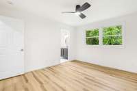 Primary bedroom view to on-suite full bath. Tile floors and more natural light