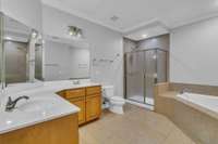 Double vanities, tile flooring, separate extended shower.