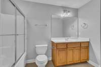 Secondary bath up with tile flooring
