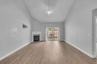 LVP flooring continues into great room with gas fireplace.