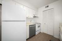 Behind the door is the stackable washer/dryer, pantry, and water heater