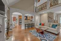 This view shows the grace of the arch entries, the family room, the breakfast bar, and the catwalk.
