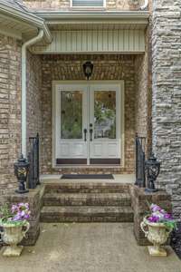 A covered porch and double front doors say welcome anytime.