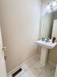 Brand new flooring and pedestal sink.  (This room had carpet previously)