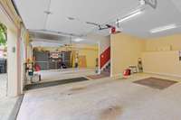 3 car garage with work bench and storage