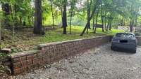 Retaining wall professionally installed adds style to vital function to control water drainage.