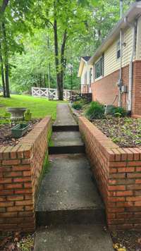 Staggered steps to front door with plenty of flower bed space.