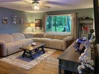 Large window overlooks front yard.